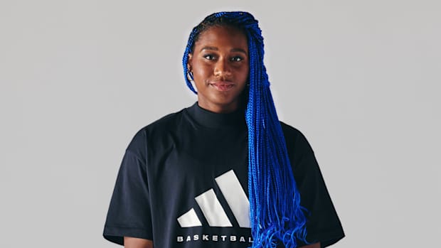 Aliyah Boston poses in a black Adidas shirt.